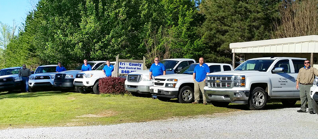tri-county pest control techs by their vehicles